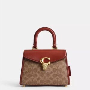 100% Authentic Coach Sammy Top Handle Bag 21 in signature Canvas.